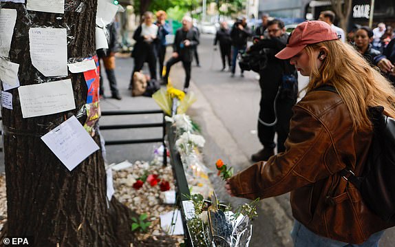 epa11664594 People gather to lay flowers and light candles outside the hotel where British musician Liam Payne was found dead the previous night, in Buenos Aires, Argentina, 17 October 2024. Liam Payne, former member of the British band One Direction, died on 16 October in Buenos Aires after falling from the third floor of a hotel, according to police.  EPA/JUAN IGNACIO RONCORONI