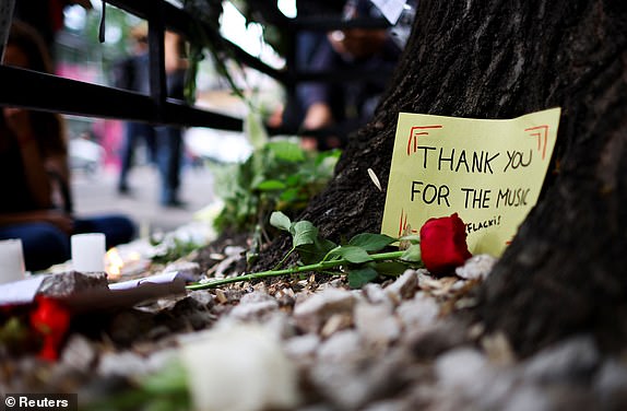 A message and a flower are left outside the hotel where Liam Payne, former One Direction band member, was found dead after he fell from a third-floor hotel room balcony, in Buenos Aires, Argentina, October 17, 2024. REUTERS/Agustin Marcarian     TPX IMAGES OF THE DAY