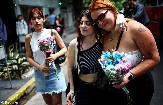 People react outside the hotel where Liam Payne, former One Direction band member, was found dead after he fell from a third-floor hotel room balcony, in Buenos Aires, Argentina, October 17, 2024. REUTERS/Agustin Marcarian