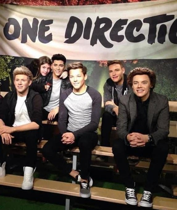 Undated family handout photo issued by Kyra Parry of herself, pictured with a waxwork of One Direction at Madame Tussauds in London in 2011. Kyra, now 20-years-old, has been following the band since she was eight-years-old, in 2010. The student from Stoke-on-Trent has said that One Direction fans have lost "a big part of their childhood" after the death of Liam Payne, saying he had "major star quality". Issue date: Thursday October 17, 2024. PA Photo. Former One Direction star Liam Payne has died at the age of 31, after falling from a hotel balcony in Buenos Aires, Argentina. See PA story DEATH PayneFans. Photo credit should read: Kyra Parry/Family Handout/PA Wire NOTE TO EDITORS: This handout photo may only be used for editorial reporting purposes for the contemporaneous illustration of events, things or the people in the image or facts mentioned in the caption. Reuse of the picture may require further permission from the copyright holder.