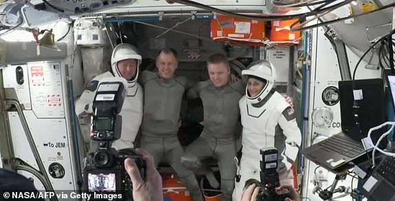 This screengrab made from a NASA video shows astronauts Butch Wilmore (L) and Suni Williams (R) posing for pictures before departing from the International Space Station on March 18, 2025. A pair of astronauts stranded in space for more than nine months were finally headed home on March 18 after their capsule undocked from the International Space Station. The SpaceX craft carrying Butch Wilmore and Suni Williams detached from the orbital outpost at 0505 GMT, ending their prolonged mission that has captivated global attention. (Photo by NASA / AFP) / RESTRICTED TO EDITORIAL USE - MANDATORY CREDIT "AFP PHOTO / NASA  " - NO MARKETING NO ADVERTISING CAMPAIGNS - DISTRIBUTED AS A SERVICE TO CLIENTS (Photo by -/NASA/AFP via Getty Images)