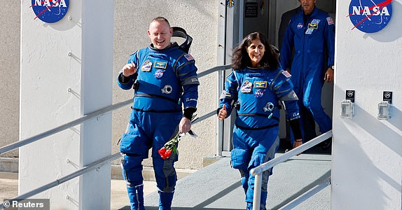 FILE PHOTO: NASA astronauts Butch Wilmore and Suni Williams walk at NASA's Kennedy Space Center, on the day of Boeing's Starliner-1 Crew Flight Test (CFT) mission on a United Launch Alliance Atlas V rocket to the International Space Station, in Cape Canaveral, Florida, U.S., June 1, 2024. REUTERS/Joe Skipper/File Photo