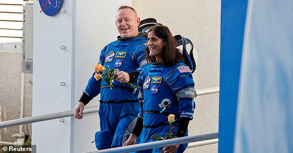 FILE PHOTO: NASA astronauts Butch Wilmore and Sunita Williams walk at NASA's Kennedy Space Center, ahead of Boeing's Starliner-1 Crew Flight Test (CFT) mission on a United Launch Alliance Atlas V rocket to the International Space Station, in Cape Canaveral, Florida, U.S., June 5, 2024. REUTERS/Joe Skipper/File Photo