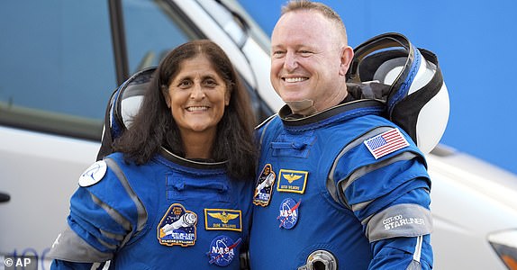 FILE - NASA astronauts Suni Williams, left, and Butch Wilmore stand together for a photo enroute to the launch pad at Space Launch Complex 41 Wednesday, June 5, 2024, in Cape Canaveral, Fla., for their liftoff on a Boeing Starliner capsule to the International Space Station. (AP Photo/Chris O'Meara, File)