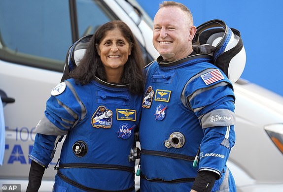 NASA astronauts Suni Williams, left, and Butch Wilmore pose for a photo after leaving the operations and checkout building for a trip to launch pad at Space Launch Complex 41 Wednesday, June 5, 2024, in Cape Canaveral, Fla. The two astronauts are scheduled to liftoff later today on the Boeing Starliner capsule for a trip to the international space station. (AP Photo/Chris O'Meara)